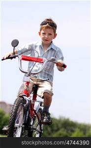 little boy goes for a drive on a bicycle