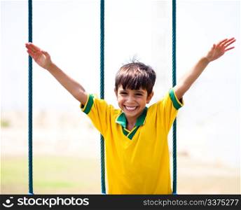 Little boy having fun as he runs with arms wide open