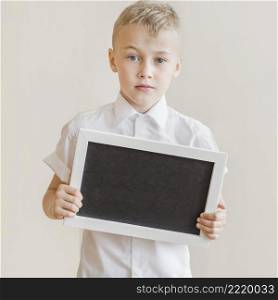 little boy holding blackboard studio