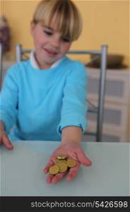 Little boy holding coins