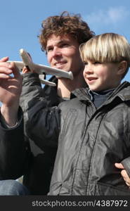 Little boy holding model plane
