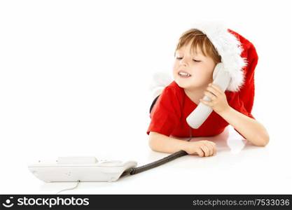 Little boy in a cap of santa calls by phone, isolated