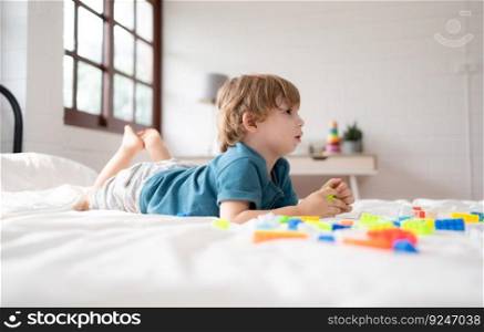 Little boy in his bedroom with a new toy purchased by his parents to help him improve his thinking skills.