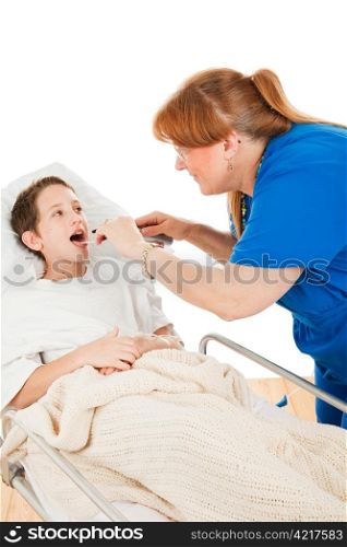 Little boy in the hospital opening his mouth so a nurse can examine his throat. Isolated on white.