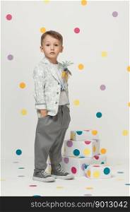 little boy in the trendy and designer suits and sneakers on a white background. little boy in a suit