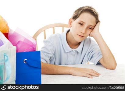 Little boy is bored waiting to open his birthday presents. White background.