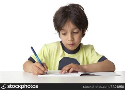Little boy is writing in his notebook