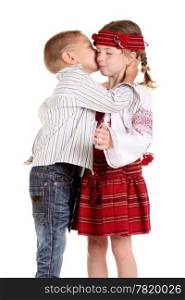 Little boy kissing a little girl on the white background
