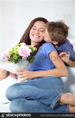 Little boy kissing his mom on mother&acute;s day