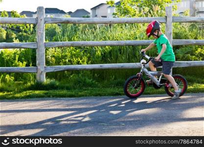 Little boy learning how to ride his bike