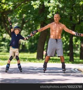 Little boy learning how to roller skate with his grandfather