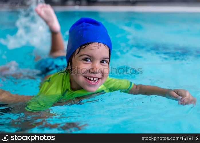 Little boy learning to swim