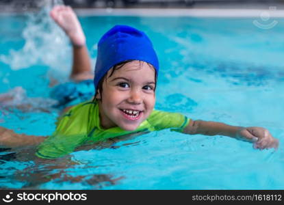 Little boy learning to swim