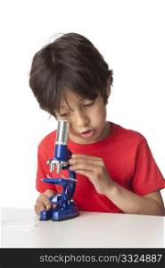 Little boy looking through a microscope