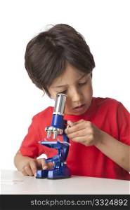 Little boy looking through a microscope