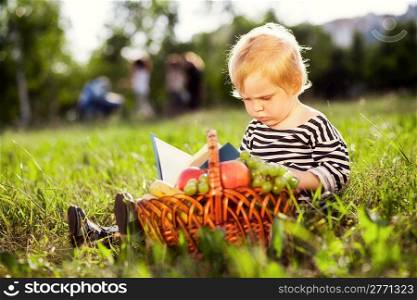 little boy looks at a book