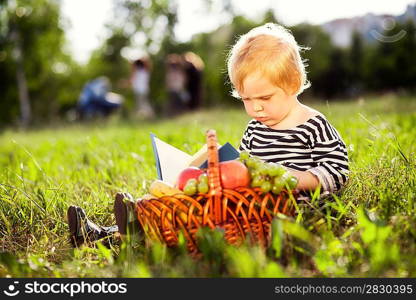 little boy looks at a book