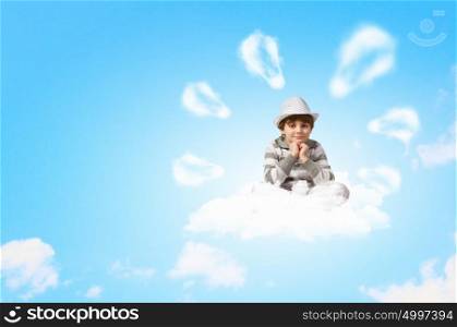 Little boy meditating. Image of little boy sitting on clouds and relaxing