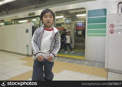 little boy outside a train