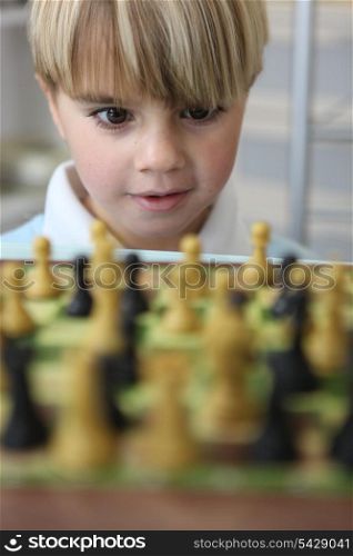 little boy playing chess