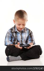 Little boy playing games on smartphone or reading a text message isolated on white background