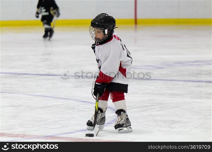 Little boy playing ice hockey