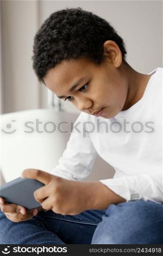 little boy playing mobile