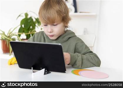 little boy playing tablet