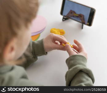 little boy playing while looking smartphone