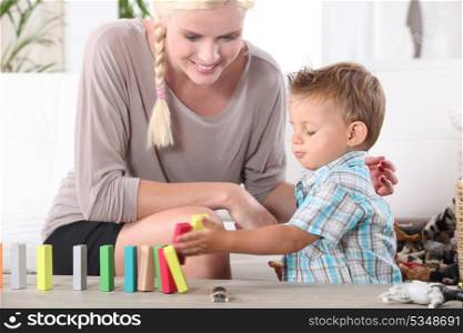 Little boy playing with building blocks