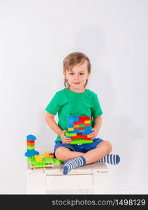 Little boy playing with lots of colorful plastic blocks constructor indoor.. Little boy playing with lots of colorful plastic blocks constructor .