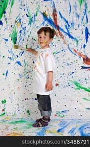 Little boy playing with painting with the background painted