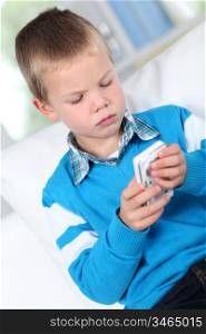 Little boy playing with smartphone
