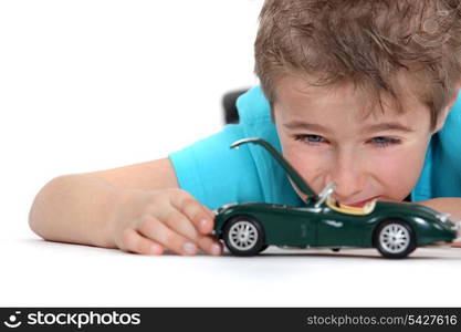 Little boy playing with toy car