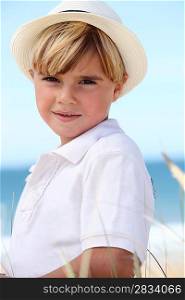 little boy posing on the beach