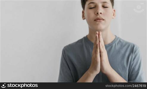 little boy praying with copy space