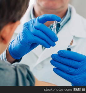 Little boy receives a vaccination in the doctors office.