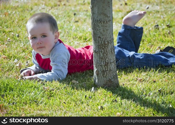 Little boy resting from busy time playing in the back yard.