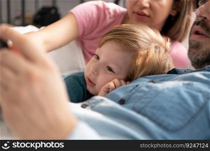 Little boy’s father read stories to children before going to bed to unwind and sleep soundly until the morning.