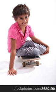 Little boy sat on skateboard
