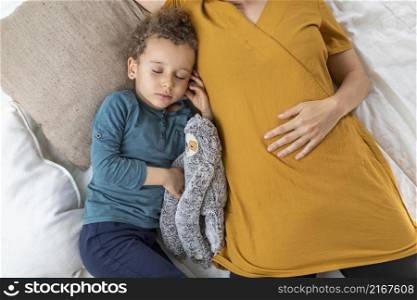 little boy sleeping his mother
