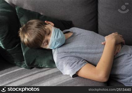little boy sleeping with medical mask