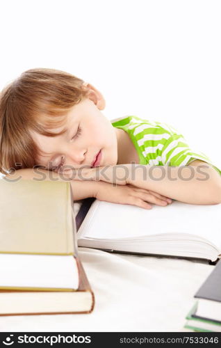 Little boy sleeps on a heap of the books, isolated