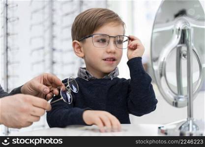 little boy store trying glasses