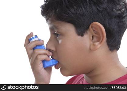Little boy using an inhaler