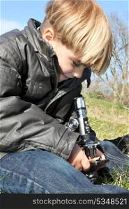 Little boy using microscope