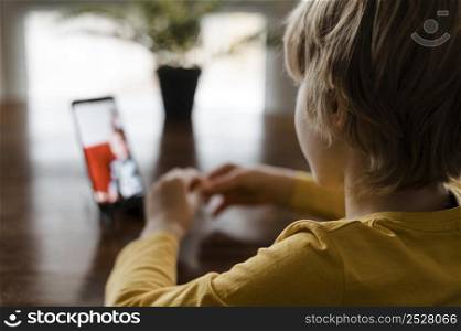 little boy using smartphone home