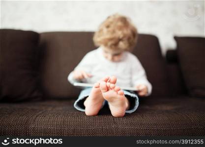 Little boy using tablet computer, indoor