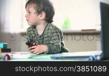 Little boy watching cartoons on laptop