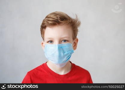 Little boy wearing a mask against corona virus covid-19, 2019-nCov. Kid in a surgical bandage or respirator during corona virus and flu outbreak. Child in a medical mask. Coronavirus quarantine.